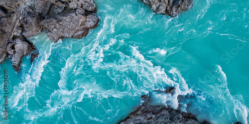 Banner Blue turquoise water of mountain Katun river between rocks, aerial top view