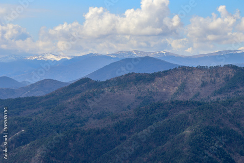 A landscape photo of ridges and bright blue sky in the background.