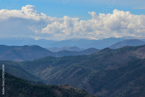 A landscape photo of ridges and bright blue sky in the background.