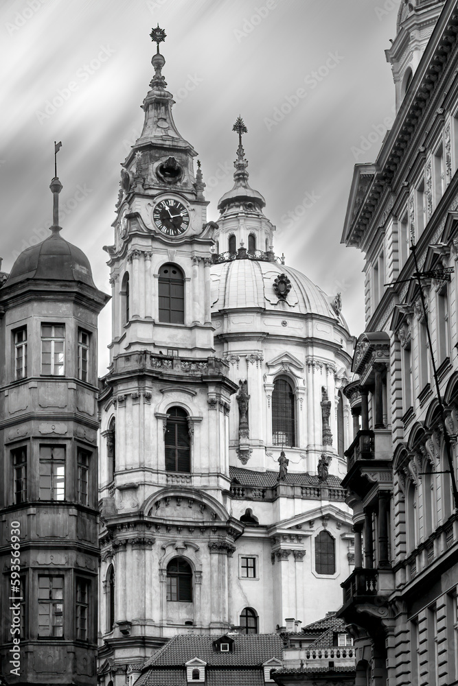 Black and white vertical shot of historical St.Nicholas church in the historical center of Prague. Beautiful medieval religious architecture. Mala Strana disctrict.