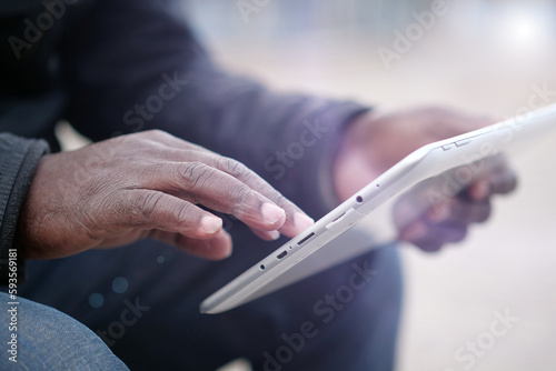African american man uses tablet computer. Black man hands holds tablet pc