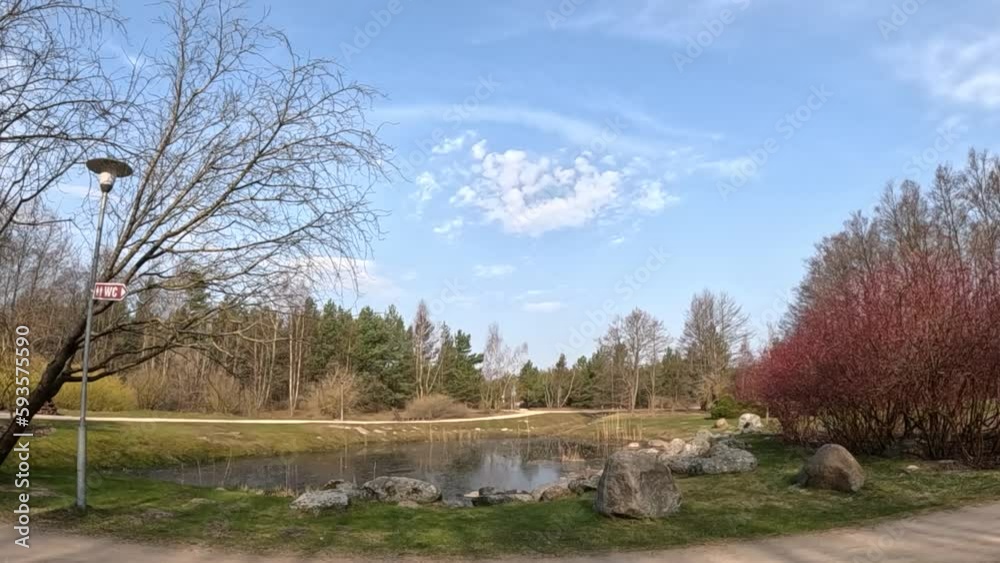 A pond in the centre. Nearby trees, big rocks and a beautiful sky A pond in the centre. Nearby trees, big rocks and a beautiful sky