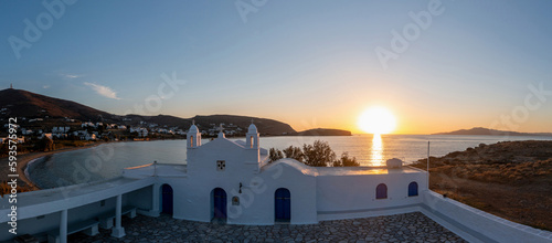 Fototapeta Naklejka Na Ścianę i Meble -  Tinos island, Cyclades Greece. Aerial drone view of Agios Sostis church at sunset, sea, blue sky.