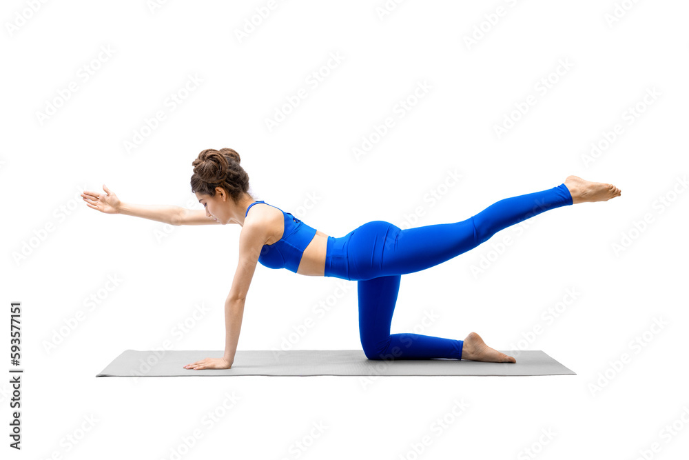 Young fit woman in blue sportswear does bird dog drill with one leg and arm up, isolated on white.
