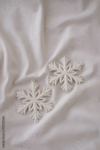 White snowflake on white fabric. Christmas and New Year concept. photo