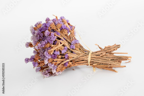 bunch of dried highland flowers. golden flower. white background. purple wild flowers