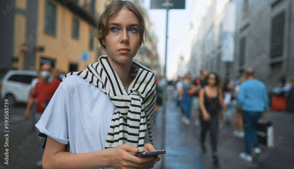 Fototapeta premium Portrait of teenage girl in crowded city.