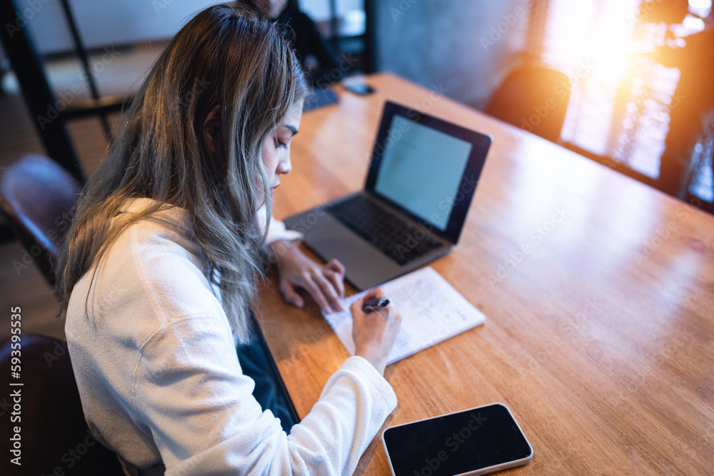 A female college student with a laptop doing research and self-study in the study room. Education stock photo A female college student with a laptop doing research and self-study in the study room. Education stock photo