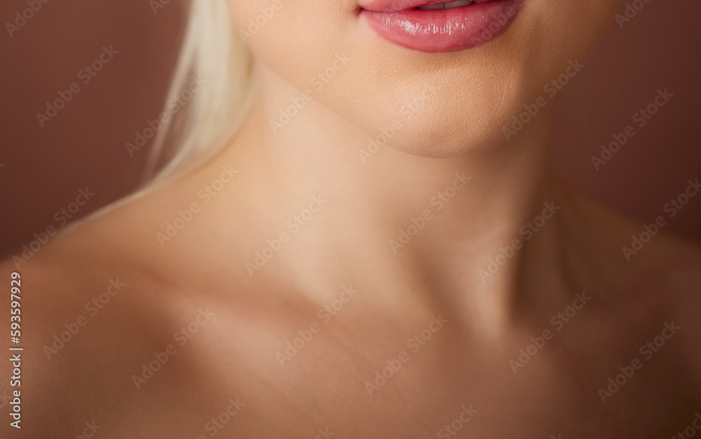 young women's neck shoulder and collarbone on brown nude background young women's neck shoulder and collarbone on brown nude background