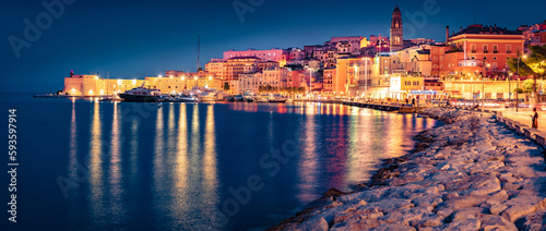 Fotografie Illuminated quay in Gaeta town with Cathedral Basilica of Gaeta church on background