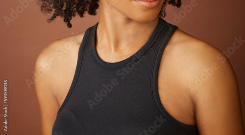 young women's neck shoulder and collarbone on brown nude background