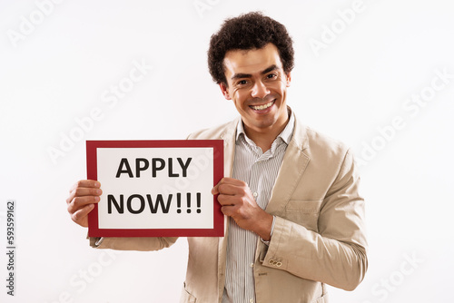 Image of businessman holding paper with text apply now.