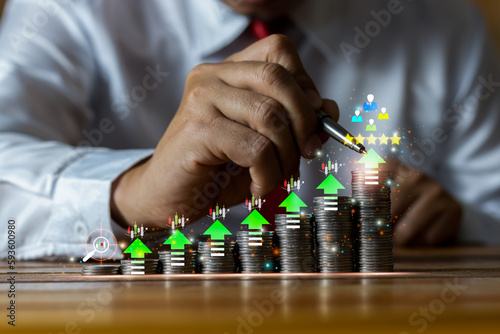 Businessman putting money coins with up arrow and yearly growth symbol for finance bank increase interest rate or mortgage investment from business growth concept.