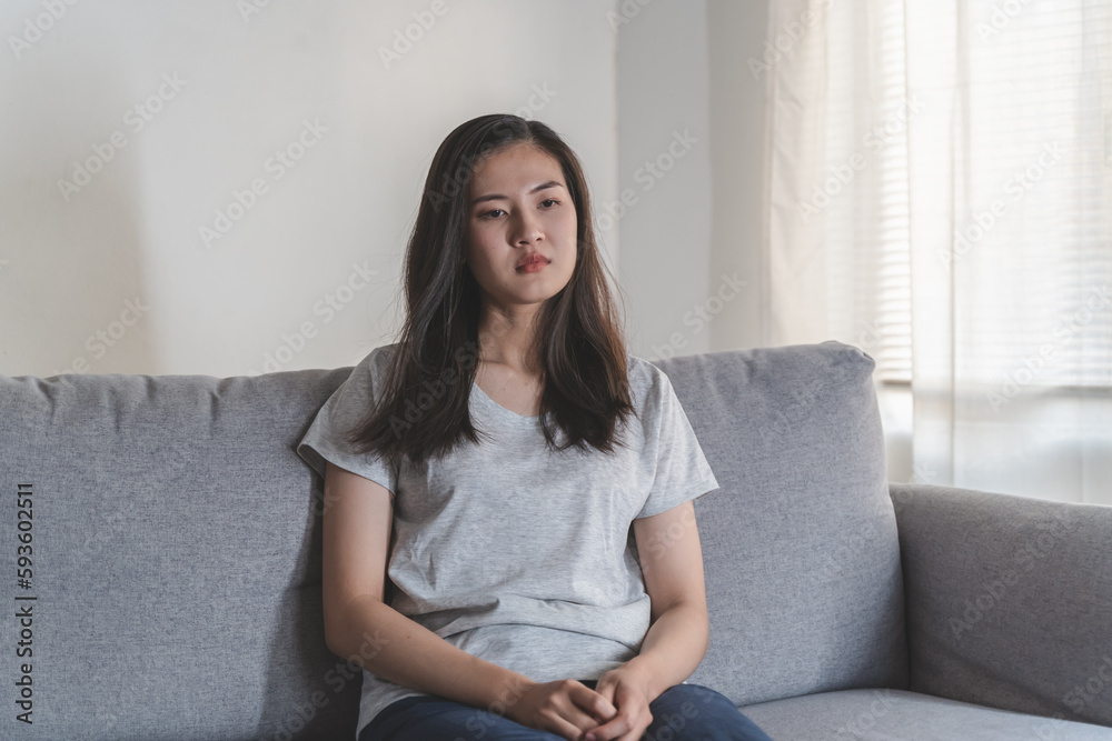 Asian woman covering her face feeling lonely and depressed sit on sofa in the room Asian woman covering her face feeling lonely and depressed sit on sofa in the room