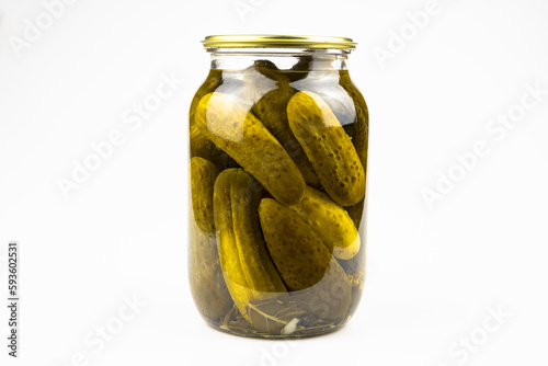 Glass jar with canned cucumbers isolated on a white background.
