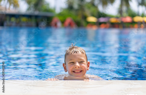 Little blond boy is having fun in the outdoor pool in Maldives © Marina