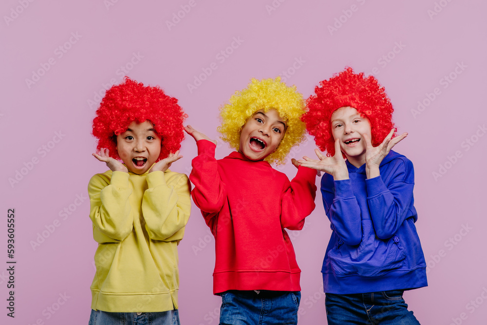 Happy children playing on clowns, studio shoot. Happy children playing on clowns, studio shoot.