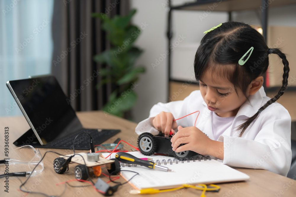 Asian littlle girl constructing and coding robot at STEM class,Fixing and repair mechanic toy car Asian littlle girl constructing and coding robot at STEM class,Fixing and repair mechanic toy car