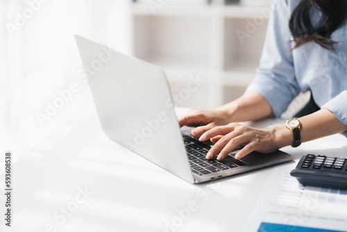 Young attractive businesswoman working on her project with laptop computer in modern office room.