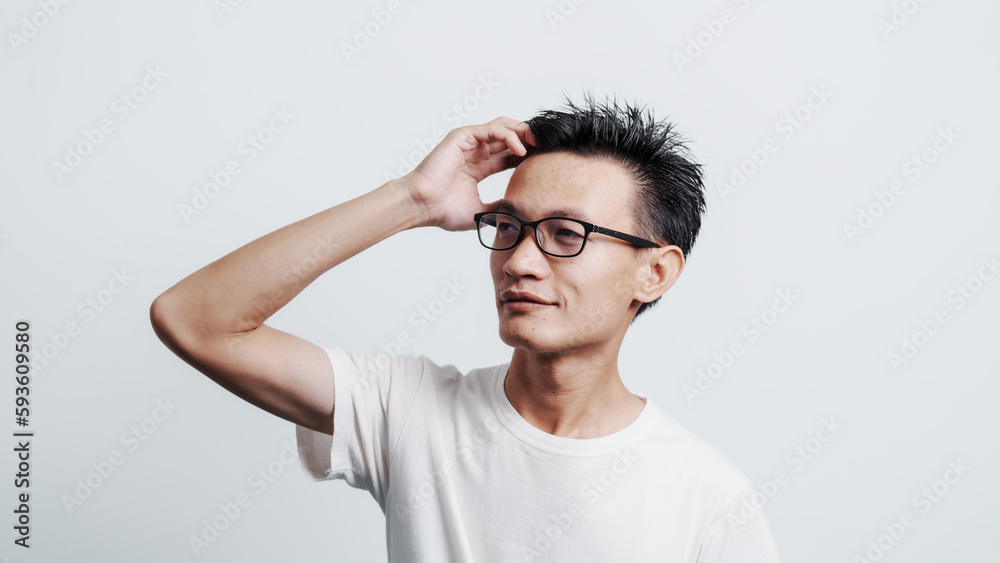 Young confident asian chinese young man checking hair style and dandruff. Young confident asian chinese young man checking hair style and dandruff.
