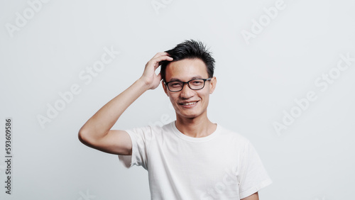 Young confident asian chinese young man checking hair style and dandruff.