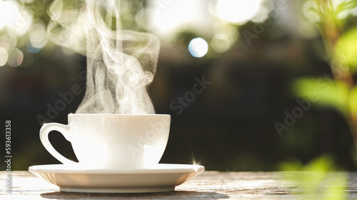 Close-up natural steam smoke of coffee from hot coffee cup on old wooden table in morning warm sunlight flare, outdoor background. Concept hot drink, Coffee Cup, Mug, espresso, breakfast