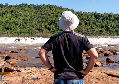 man from the back watching waterfall (Salto do Yucuma-Brazil) photo