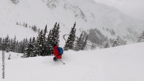 Male skier wearing Northface Red jacket backcountry skiing fresh powder snow down mountain face GoPro follow Colorado Coon Hill Eisenhower Tunnel i70 Continental Divide mountain landscape background photo