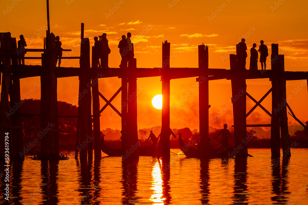 Mandalay,Myanmar, November 16, 2016: Unidentified people crossing famous U Bein bridge. The place is one of most visited sights in Burma