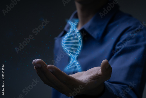 Businessman holding DNA symbol.Digital healthcare and network connection on virtual interface, medical technology and innovation concept.