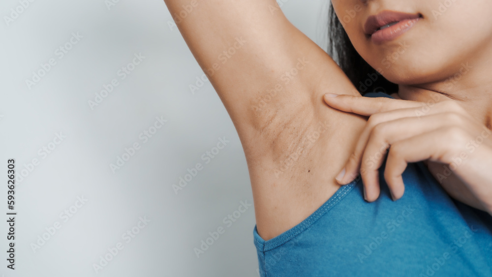 Young confident asian chinese female armpit with blue tank top isolated background. Young confident asian chinese female armpit with blue tank top isolated background.