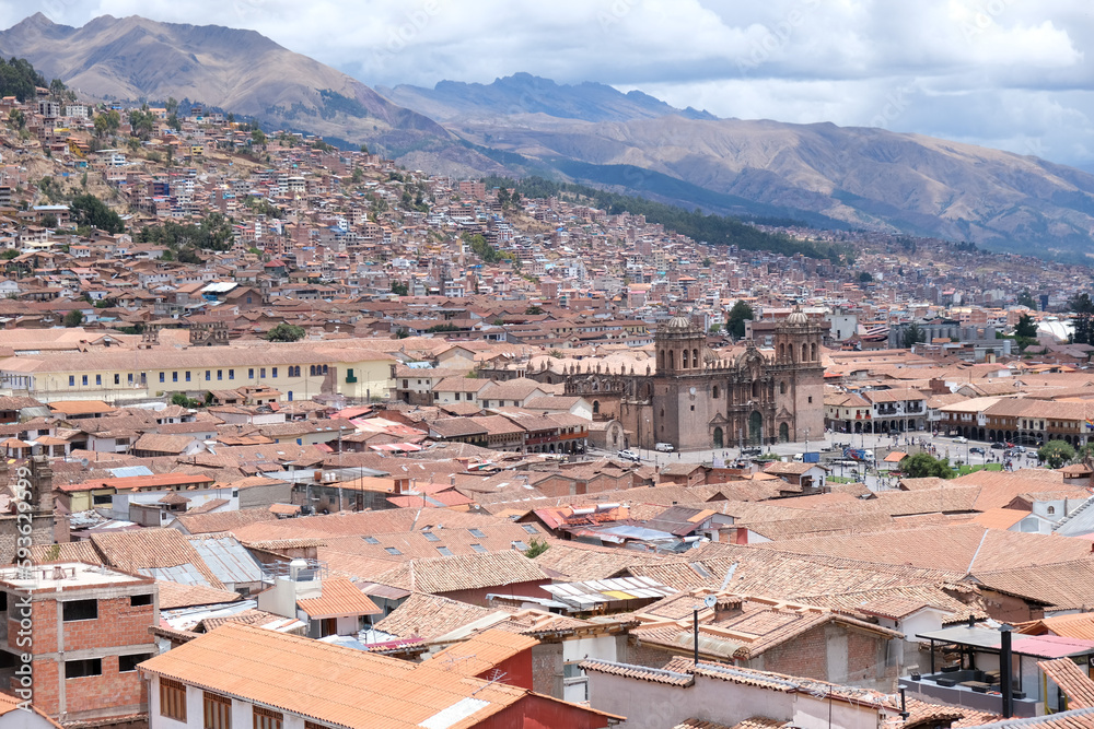 Top view houses and roof at Cusco with Andes mountains and cloudy sky background. Cusco view travel concept background. Open space area.