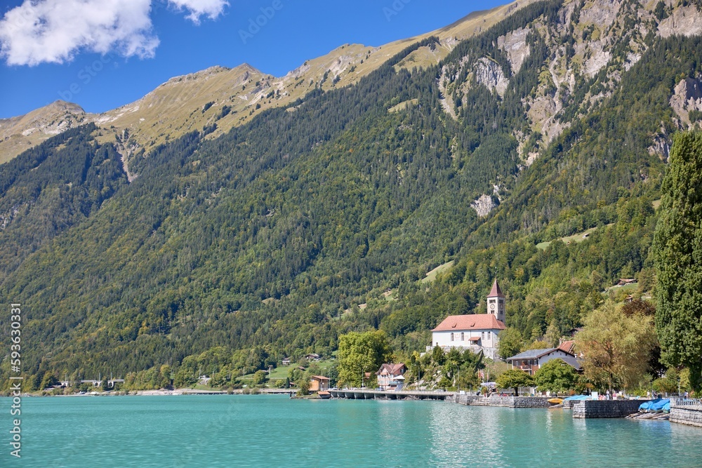 Nice sunny day at Lake Brienz in Switzerland with a mountain and houses on the lakeside