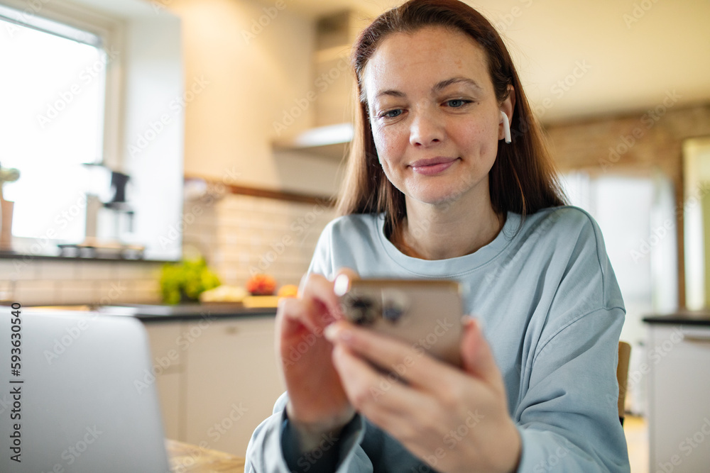 Young adult woman using her phone at home Young adult woman using her phone at home