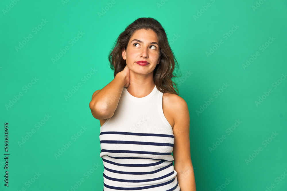 Young caucasian woman isolated touching back of head, thinking and making a choice. Young caucasian woman isolated touching back of head, thinking and making a choice.
