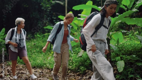young woman carrying a backpack travel and walking in the forest, Traveler woman family have a free time to relax enjoyment with nature and the tropical tree, water stream