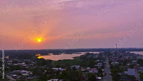 Drone made sunset with the sun still in frame and reflections on water HLG edited