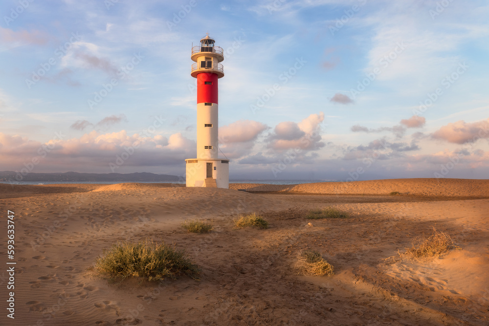 Lighthouse at El Fangar Beach at sunset,  Deltebre, Catalonia