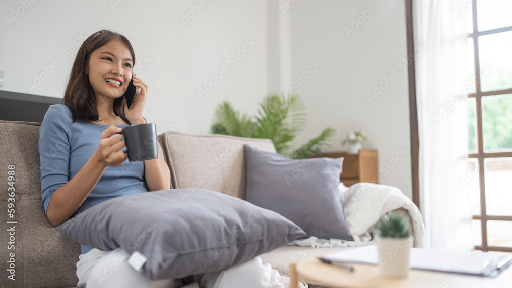 Happy young asian woman using mobile phone talking with friends on cell phone Happy young asian woman using mobile phone talking with friends on cell phone