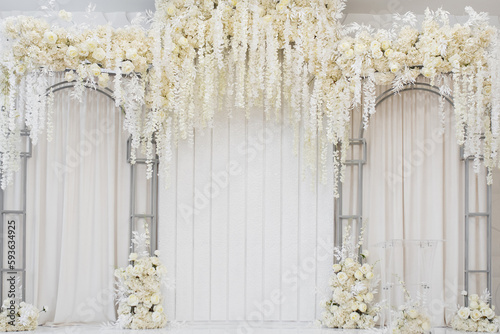 Place for wedding ceremony, copy space. Wedding arch decorated with flowers. white arch place decorated petals, flowers. Wedding reception for luxury ceremony in hall restauran