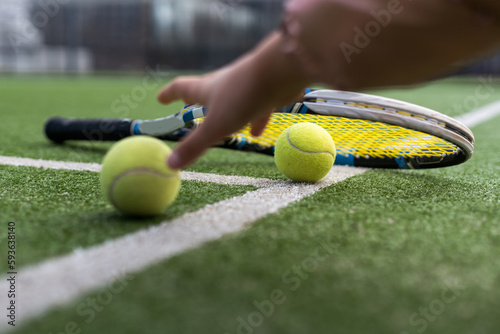 Close up of tennis rackets and tennis balls lying on tennis court. sport, tennis and activity. © Angelov