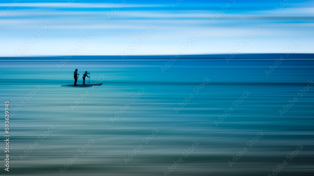 silhouette of people on the sea kayak