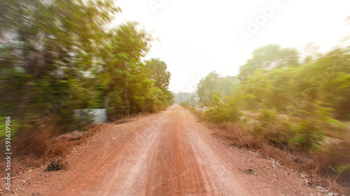 A dirt road in a rural area far from the city.