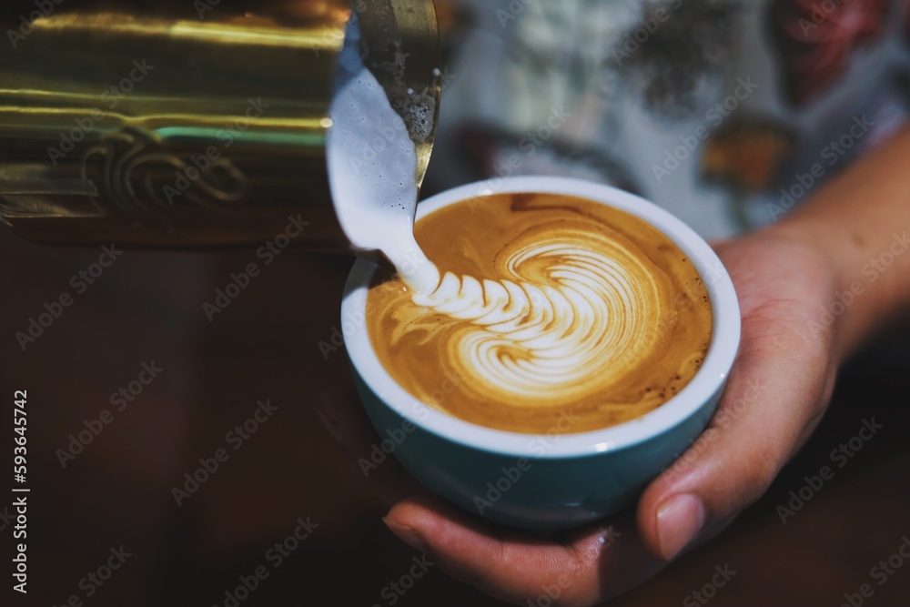 pouring coffee into a cup pouring coffee into a cup