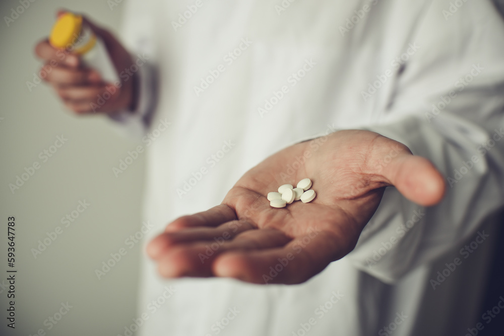 Pills in doctor's hand, white background Pills in doctor's hand, white background