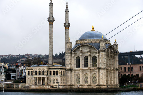 River view of the Ortakoy Mosque by the Bosphorus bridge, in Istanbul.