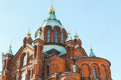 Minimalist look of orthodox russian cathedral over cloudy sky with green and gold dome