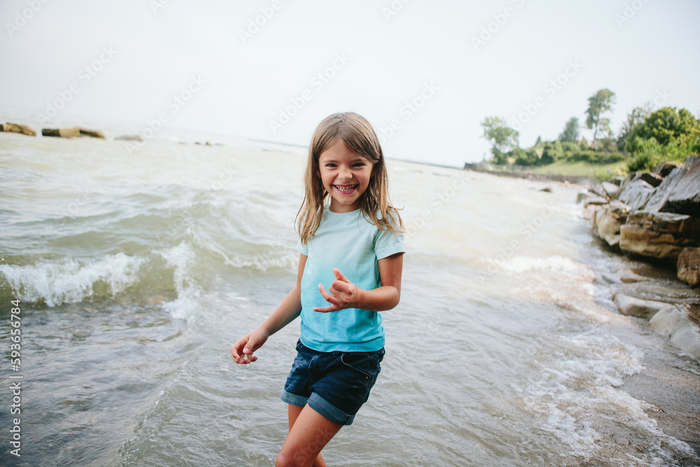Girl frolics in water at beach Girl frolics in water at beach