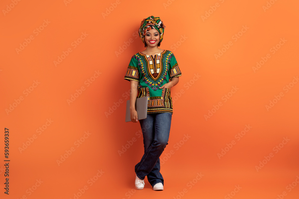 Beautiful black woman digital nomad posing with laptop