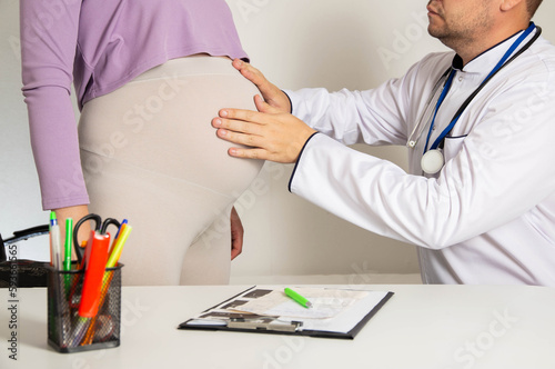 A pregnant woman at a doctor's appointment with an obstetrician-gynecologist. Complications during pregnancy in the 3rd trimester, diabetes and arterial hypertension. photo